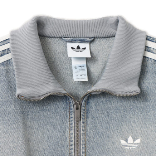 ジャケットには、スタンドカラー、トレフォイルロゴ、スリーストライプスといった象徴的なディテールを踏襲。ダブルジップ仕様により、開け方次第でシルエットやレイヤードの表情を自在にアレンジできる設計だ。